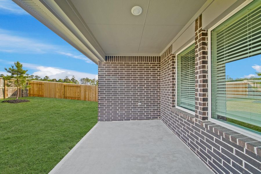 Exterior details and patio area of a home in The Canopies, Splendora (Image 3).