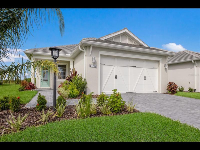 Front exterior of a new home in , Sarasota, FL, highlighting curb appeal (Image 21).