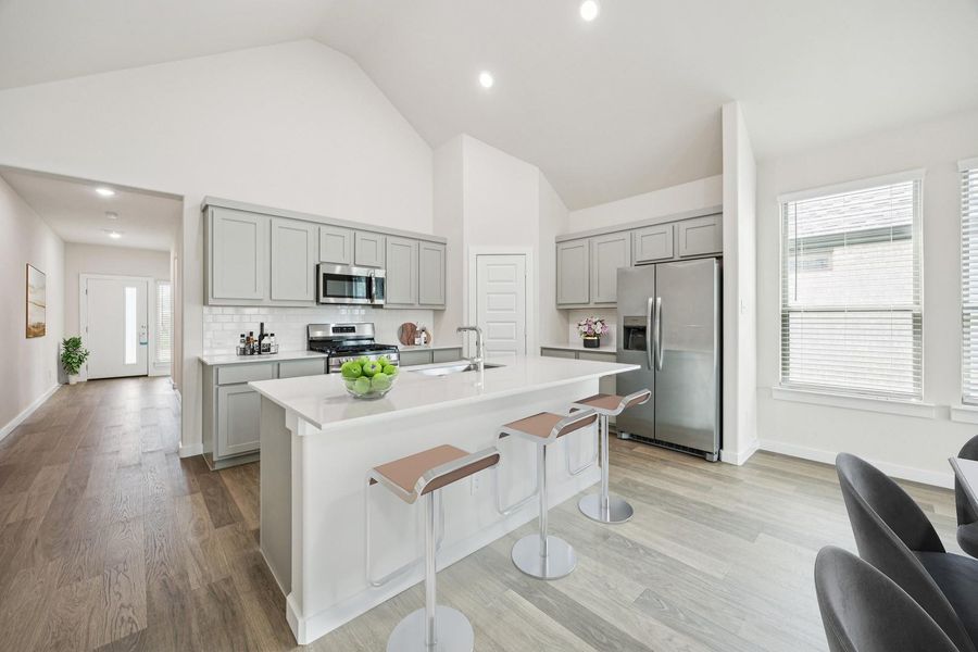 A streamlined kitchen layout offers stainless steel appliances, a generous island, and ample natural light. A streamlined kitchen layout offers stainless steel appliances, a generous island, and ample natural light.