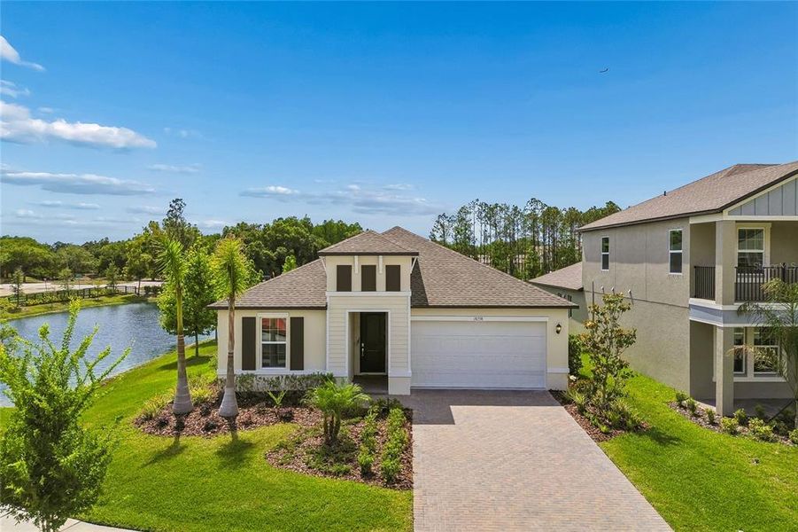 Front exterior of a new home in Pearl Estates, Lutz, FL, highlighting curb appeal (Image 26).