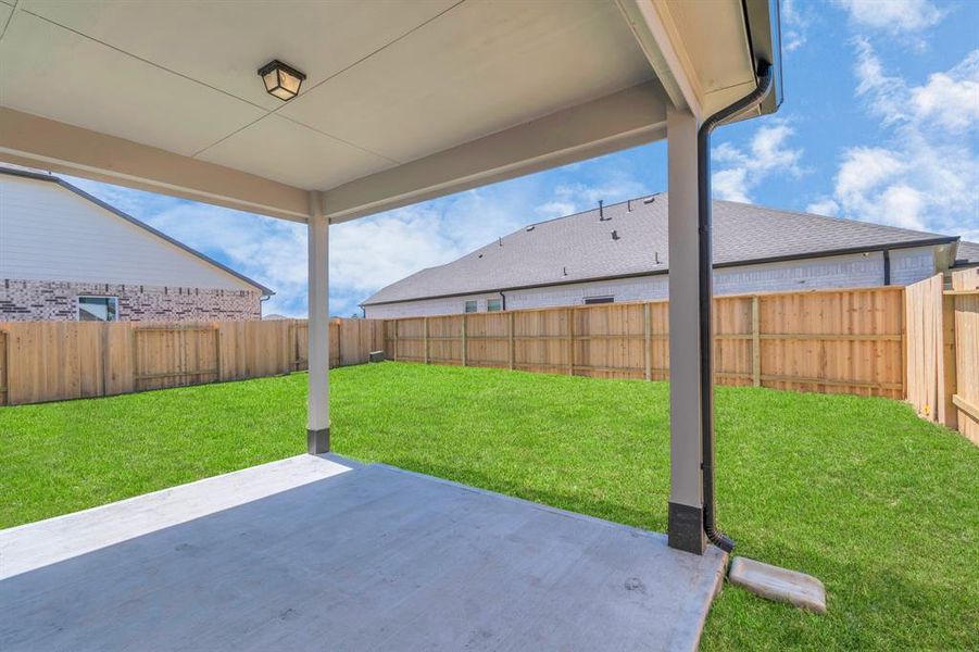 Come and see this spacious backyard with its beautiful covered patio.