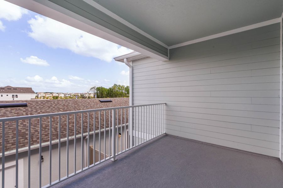 Exterior details and patio area of a home in Harvest at Ovation - Townhomes, Winter Garden (Image 3).