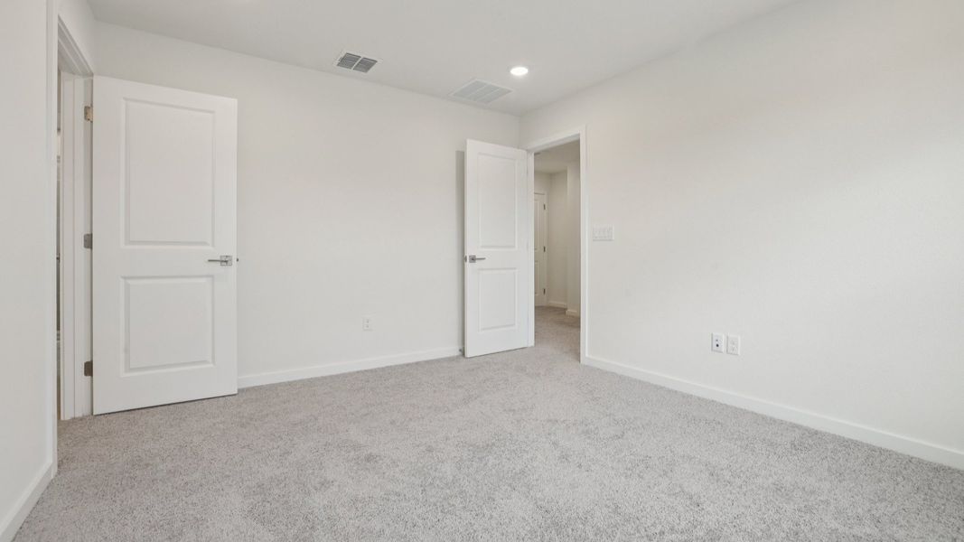 Primary suite with en suite Bath of the Coronado - End at Cyrene at Harmony located in St Cloud FL by DRB Homes