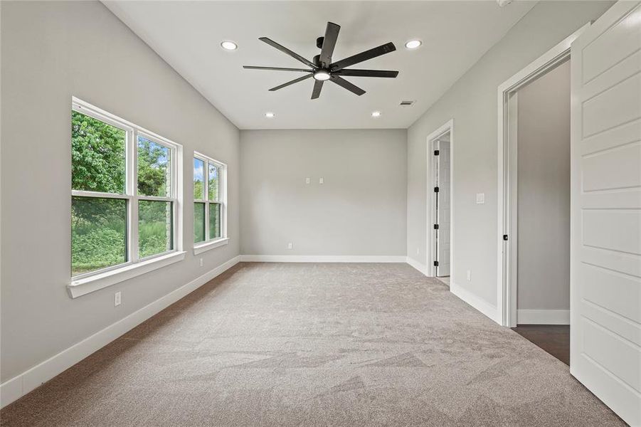 Bedroom with carpet flooring, ceiling fan, and recessed lighting