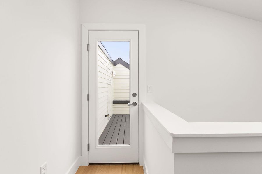 Doorway to outside with wood finished floors Doorway to outside with wood finished floors