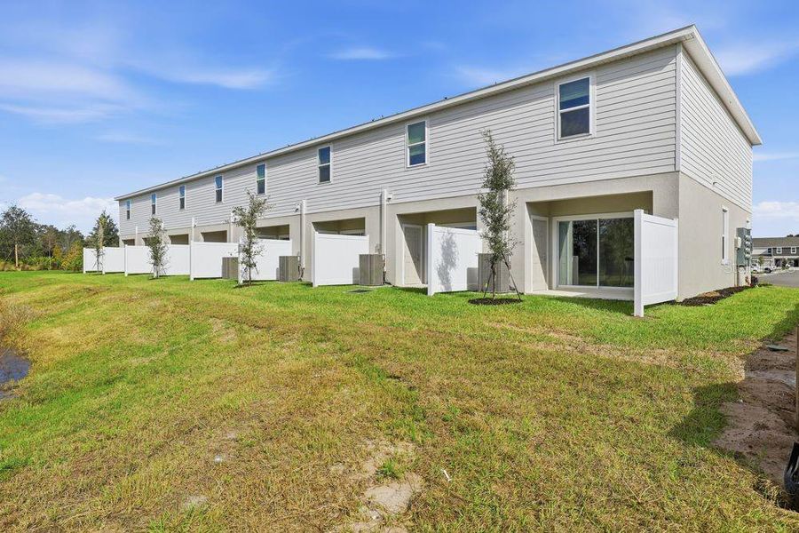 Exterior details and patio area of a home in The Towns at Firethorn, Parrish (Image 20).