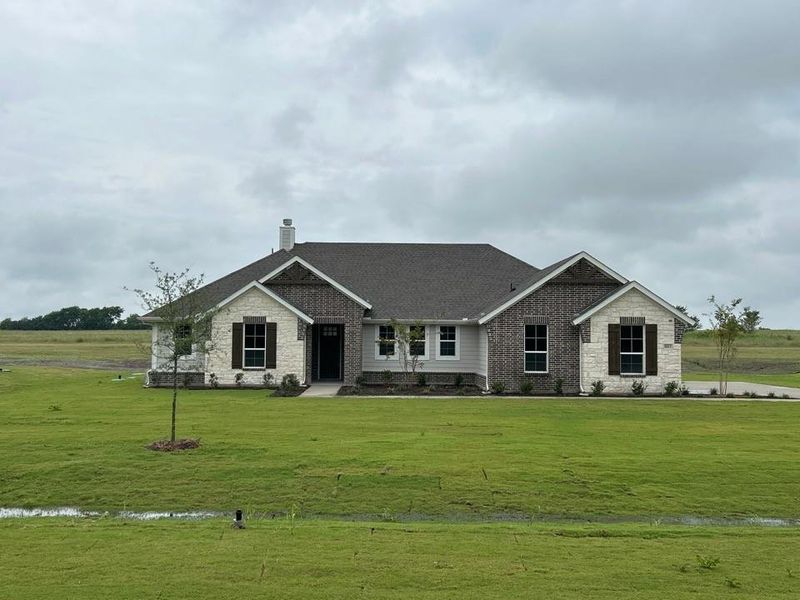 Single-story residence featuring a combination of light-colored stone, dark brick accents, and light gray siding