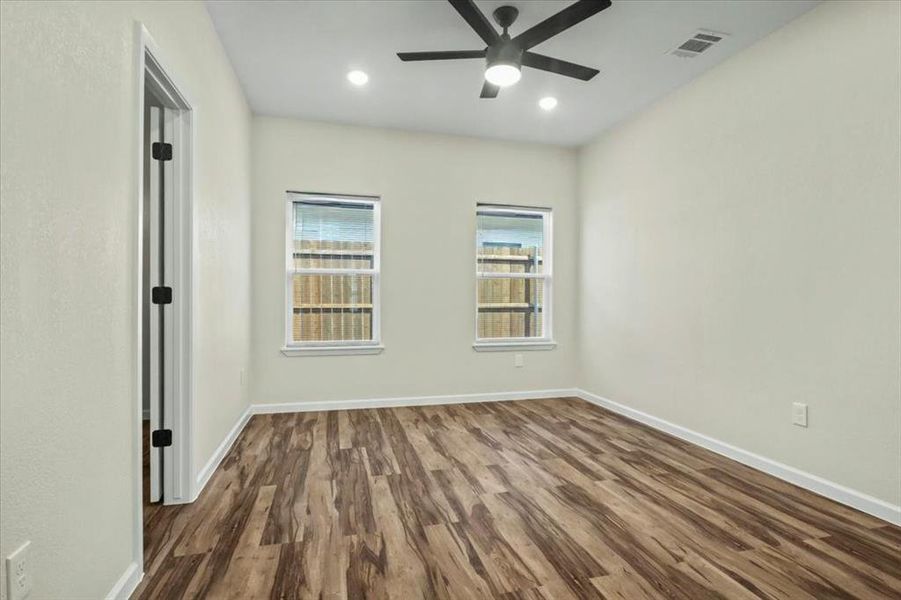 Empty room featuring dark wood-style flooring, recessed lighting, and ceiling fan Empty room featuring dark wood-style flooring, recessed lighting, and ceiling fan