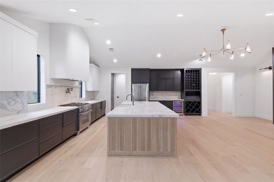 Gather with ease around the expansive island in this beautifully designed kitchen that blends luxury and practicality.
