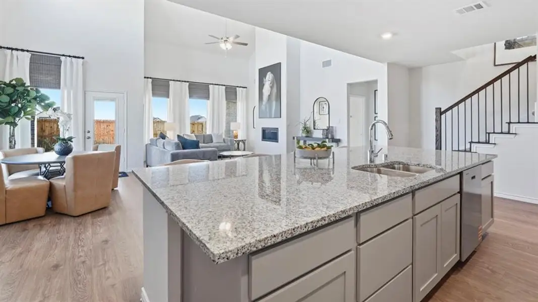 Kitchen island featuring a granite countertop, undermount sink, and contemporary faucet Kitchen island featuring a granite countertop, undermount sink, and contemporary faucet