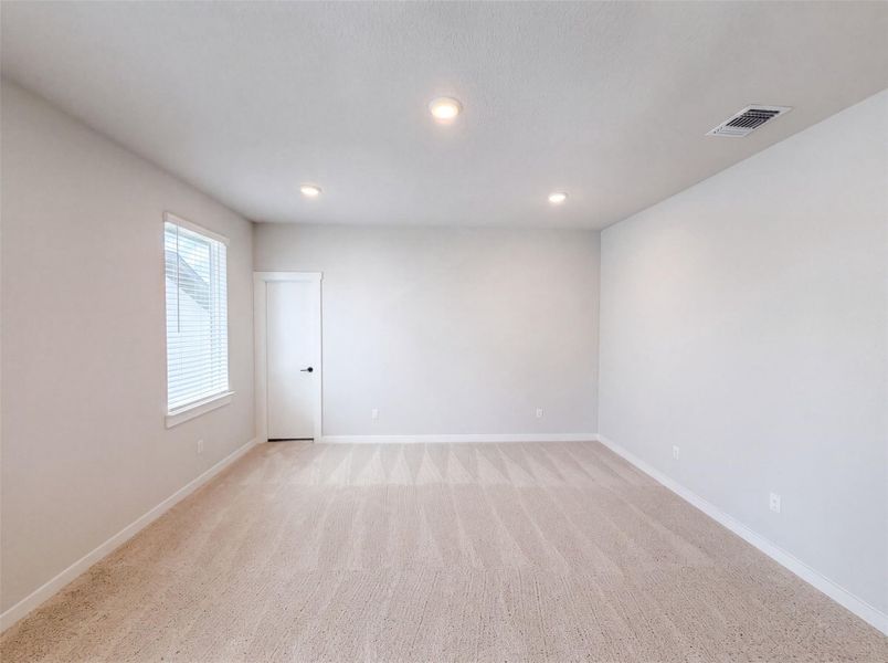 A spacious, naturally illuminated room featuring recessed lighting and plush carpeted flooring, perfect for a peaceful retreat. A spacious, naturally illuminated room featuring recessed lighting and plush carpeted flooring, perfect for a peaceful retreat.