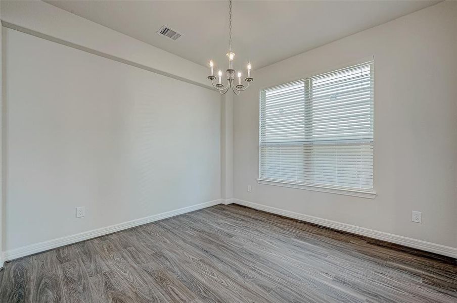 The dining room is spacious & features a wall niche.