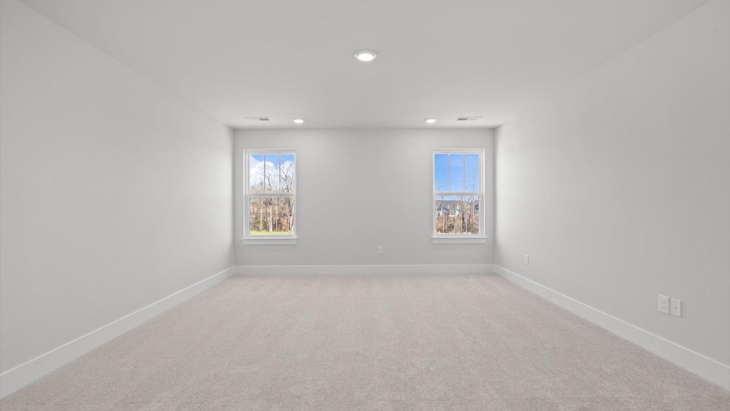 Memorable upstairs bonus room with plush carpeting and a bright, welcoming atmosphere