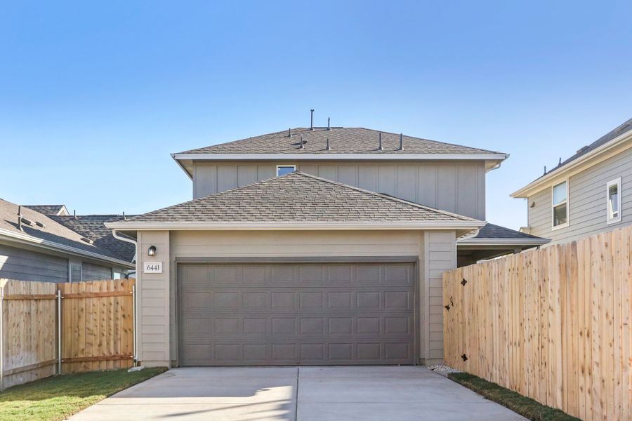 Front exterior of a new home in Porter Country, Buda, TX, highlighting curb appeal (Image 2). Front exterior of a new home in Porter Country, Buda, TX, highlighting curb appeal (Image 2).