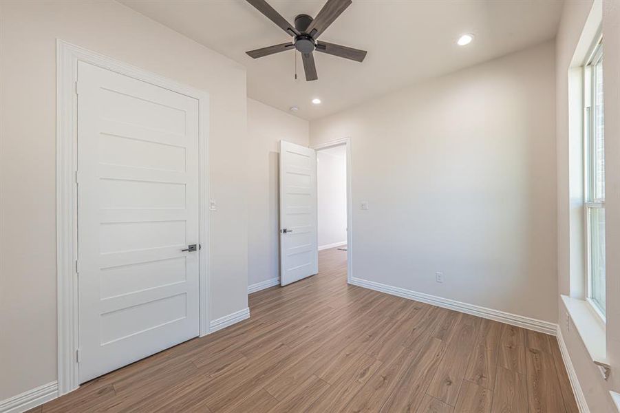 Unfurnished bedroom with wood finished floors, recessed lighting, and a ceiling fan Unfurnished bedroom with wood finished floors, recessed lighting, and a ceiling fan