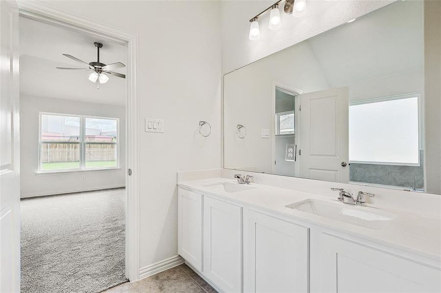 Bathroom featuring tile patterned flooring, ceiling fan, and vanity