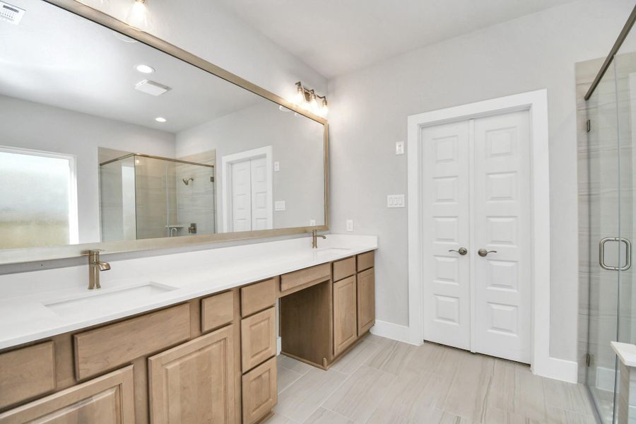Elevate your daily routine at the elegant vanity, now equipped with double sinks, light countertops, modern hardware, and beautiful vanity lights. Sample photo of completed home with similar floor plan. Actual colors and selections may vary. Elevate your daily routine at the elegant vanity, now equipped with double sinks, light countertops, modern hardware, and beautiful vanity lights. Sample photo of completed home with similar floor plan. Actual colors and selections may vary.