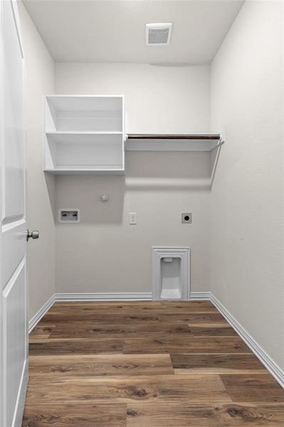 Laundry area with hookup for an electric dryer, dark wood finished floors, washer hookup, and gas dryer hookup