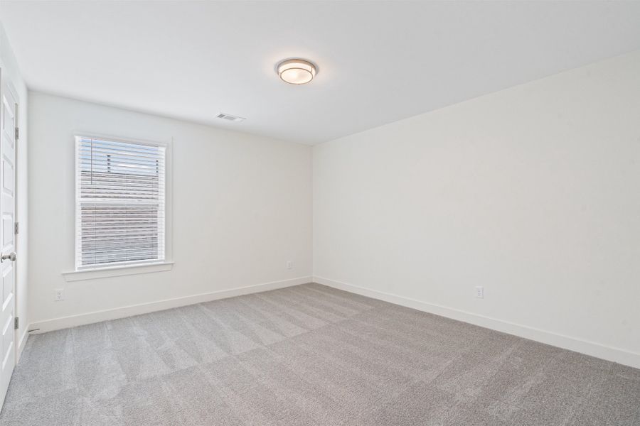 Spare room with light colored carpet
