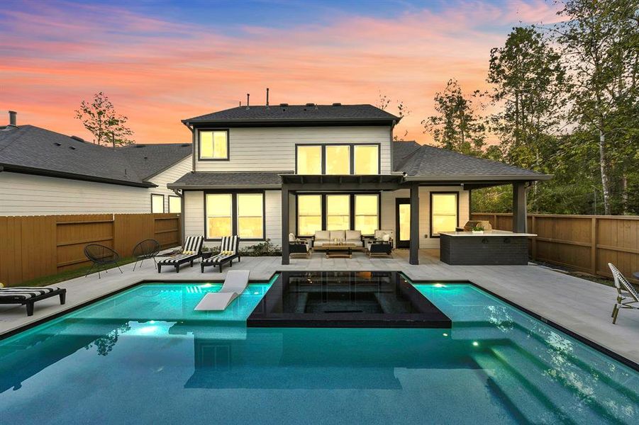 Black and white modern sleek salt water pool. Spa seating for 8.