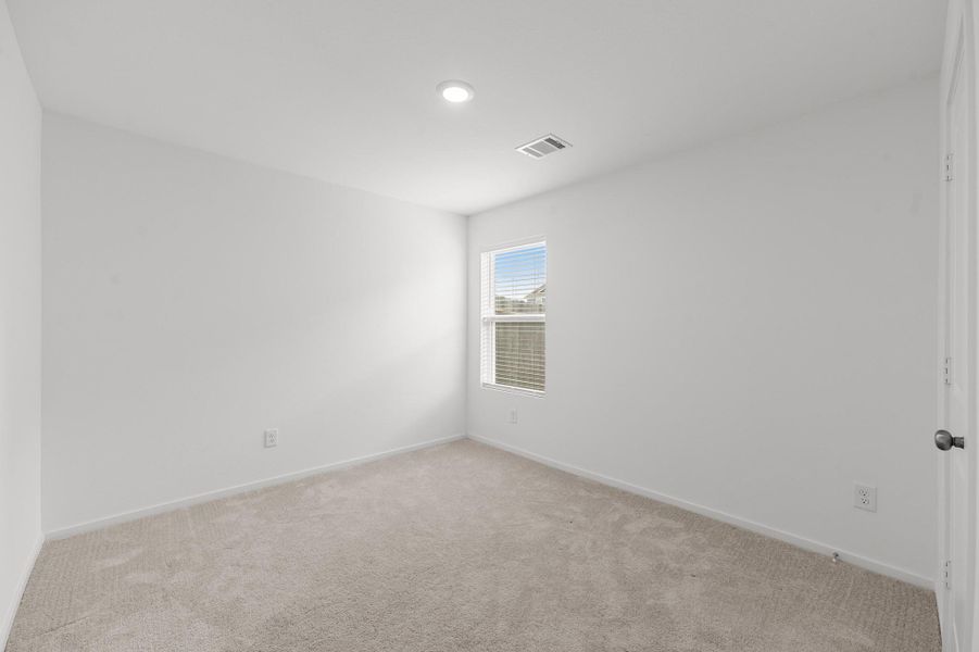 Secondary bedroom offers neutral finishes, soft carpeting, recessed lighting, and a window providing natural light. Secondary bedroom offers neutral finishes, soft carpeting, recessed lighting, and a window providing natural light.