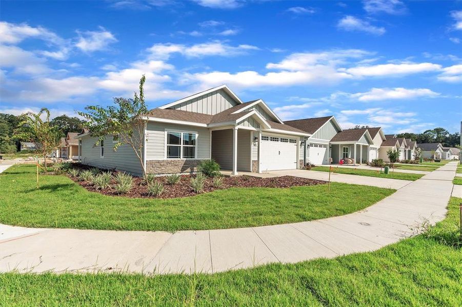 Front exterior of a new home in Grand Oaks, Gainesville, FL, highlighting curb appeal (Image 25).
