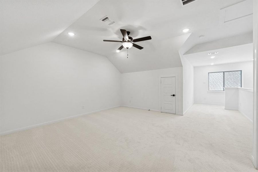 Additional living space with light carpet, recessed lighting, ceiling fan, and lofted ceiling Additional living space with light carpet, recessed lighting, ceiling fan, and lofted ceiling