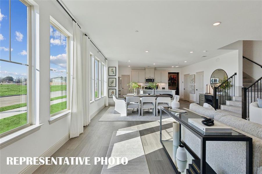 Featuring walls of windows throughout the main floor, this beautiful home is filled with natural light.  REPRESENTATIVE PHOTO