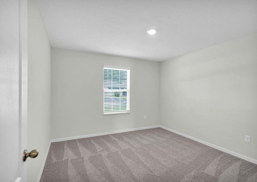 Windows let in plenty of light to this secondary bedroom.