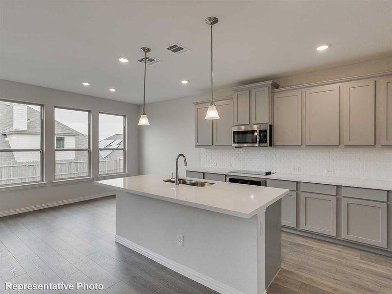 Kitchen featuring gray cabinets, backsplash, pendant lighting, appliances with stainless steel finishes, and recessed lighting
