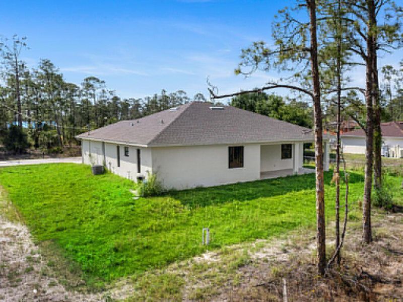 Front exterior of a new home in , Lehigh Acres, FL, highlighting curb appeal (Image 15). Front exterior of a new home in , Lehigh Acres, FL, highlighting curb appeal (Image 15).