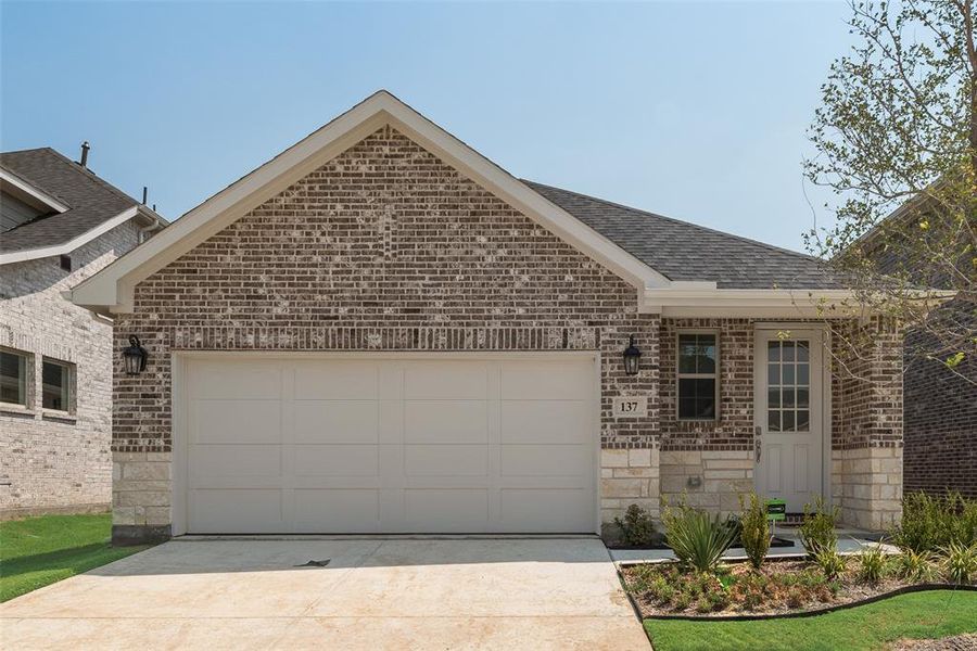 Front exterior of a new home in Spiritas Ranch, Little Elm, TX, highlighting curb appeal (Image 19). Front exterior of a new home in Spiritas Ranch, Little Elm, TX, highlighting curb appeal (Image 19).