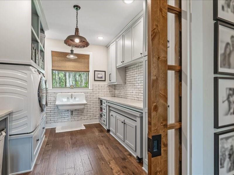 Next stop is the utility Room.  Custom cabinets that conceal cleaning products, paper products and the vacuum!  Vintage cast iron sink and pull out table for folding clothes or wrapping gifts.