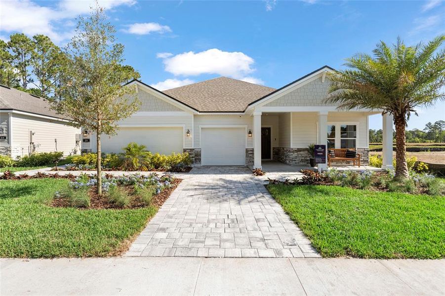 Front exterior of a new home in The Cypress Series at Reserve East, Flagler Beach, FL, highlighting curb appeal (Image 1).