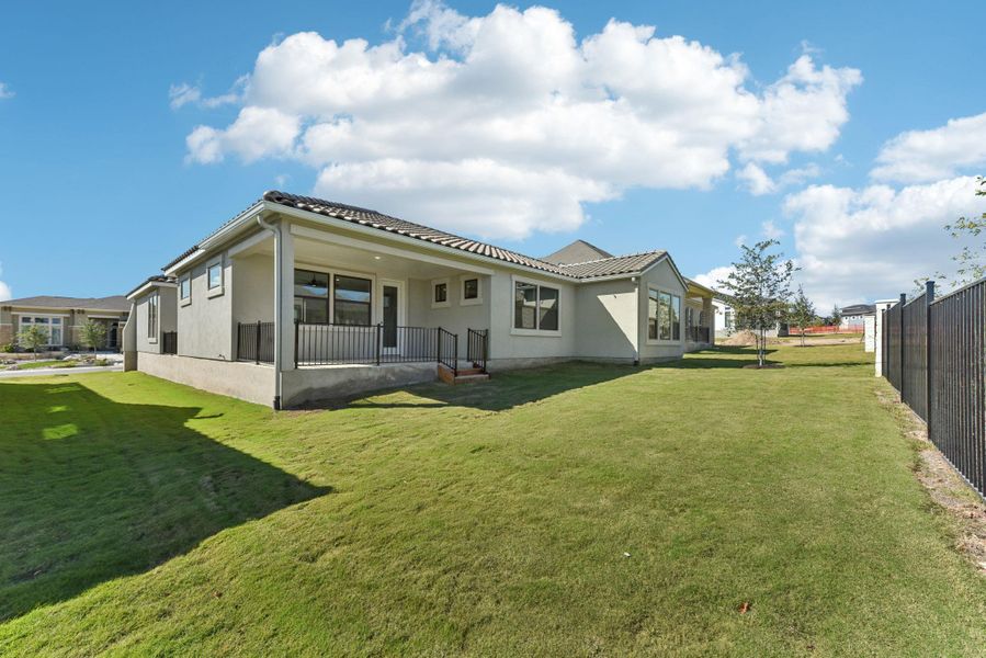 Rear view of house with stucco siding and a patio area Rear view of house with stucco siding and a patio area