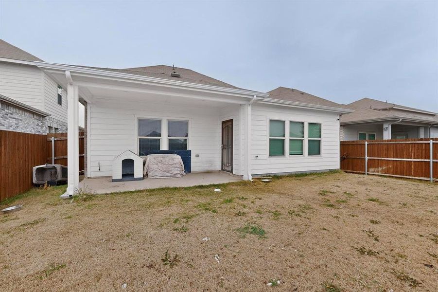 Rear view of property with a fenced backyard and a patio area Rear view of property with a fenced backyard and a patio area