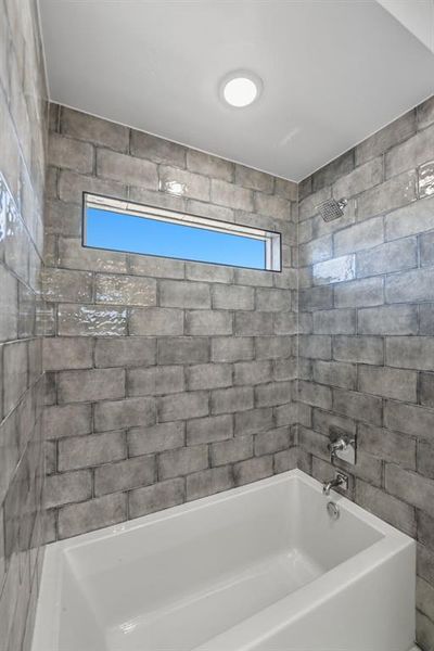 Bathroom featuring bathing tub / shower combination Bathroom featuring bathing tub / shower combination