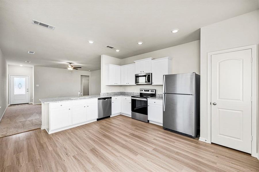 The kitchen has brand new Whirlpool kitchen appliances and granite countertops.