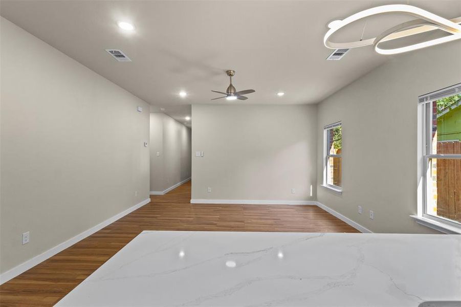 Unfurnished room with wood finished floors, recessed lighting, and ceiling fan Unfurnished room with wood finished floors, recessed lighting, and ceiling fan