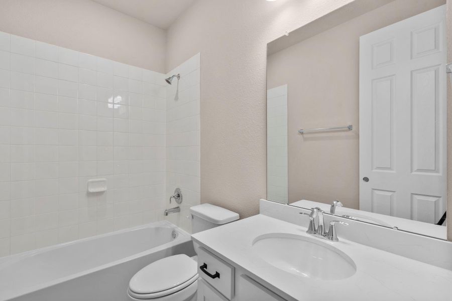 The secondary bath features tile flooring, white cabinetry and light countertops and a shower/tub combo. Perfect for accommodating any visiting family and friends. The secondary bath features tile flooring, white cabinetry and light countertops and a shower/tub combo. Perfect for accommodating any visiting family and friends.