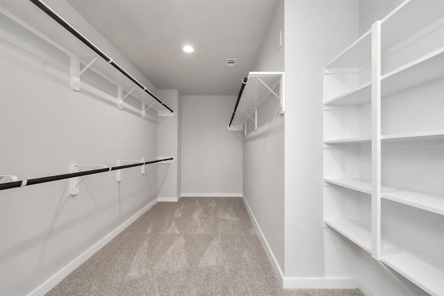 Spacious primary closet with built ins.