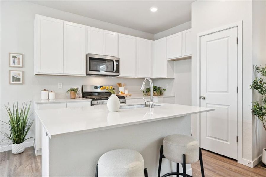 A kitchen with white cabinets. A kitchen with white cabinets.