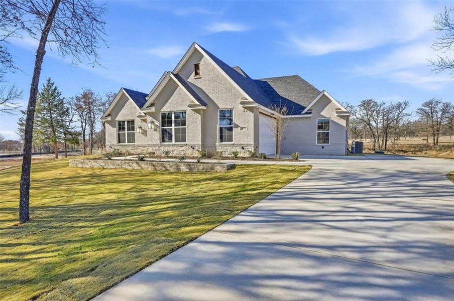 Front exterior of a new home in Escondido Ranches, Poolville, TX, highlighting curb appeal (Image 23).