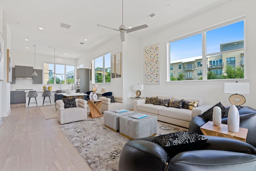 Living room with light wood-type flooring, recessed lighting, and a ceiling fan