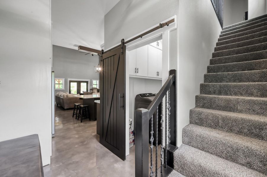 Carpeted stairs lead to the upper level