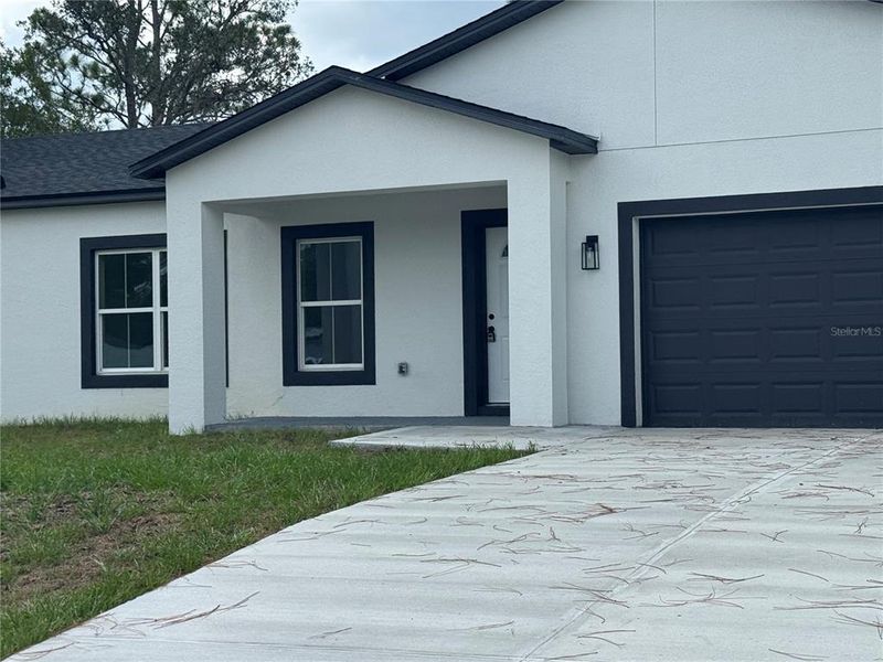 Front exterior of a new home in , Dunnellon, FL, highlighting curb appeal (Image 2).