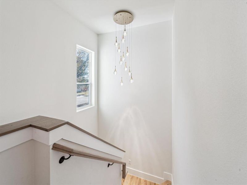 Stairway featuring hardwood / wood-style floors