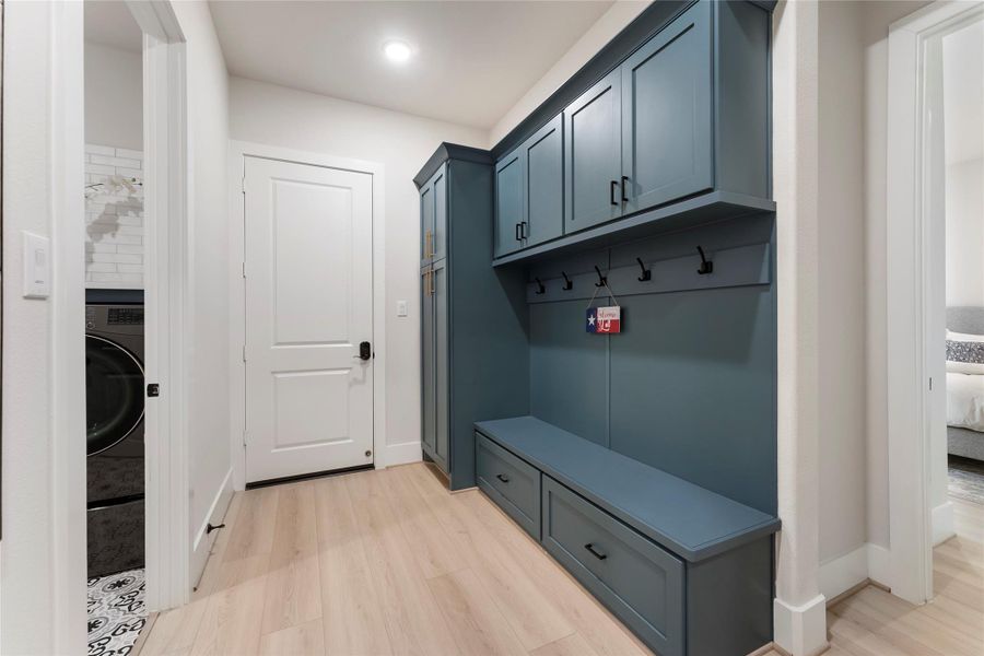 mudroom provides a practical drop zone with cabinetry, drawers, and a built in bench area. It is ideal for keeping backpacks, shoes, sports bags, and daily essentials organized.