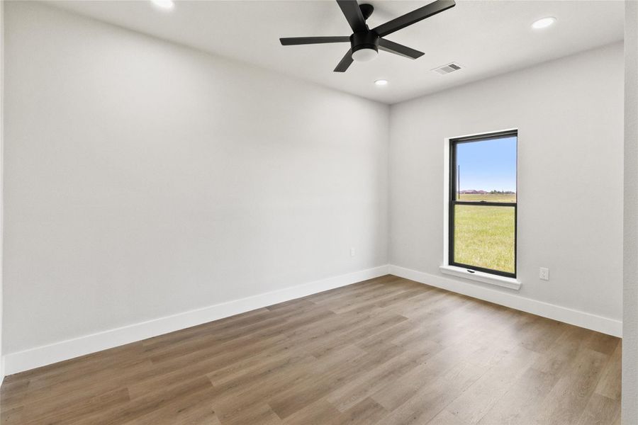 Secondary bedroom with a closet and convenient access to the full guest bathroom. Natural light and neutral finishes provide a comfortable space for guests, family, or a home office.