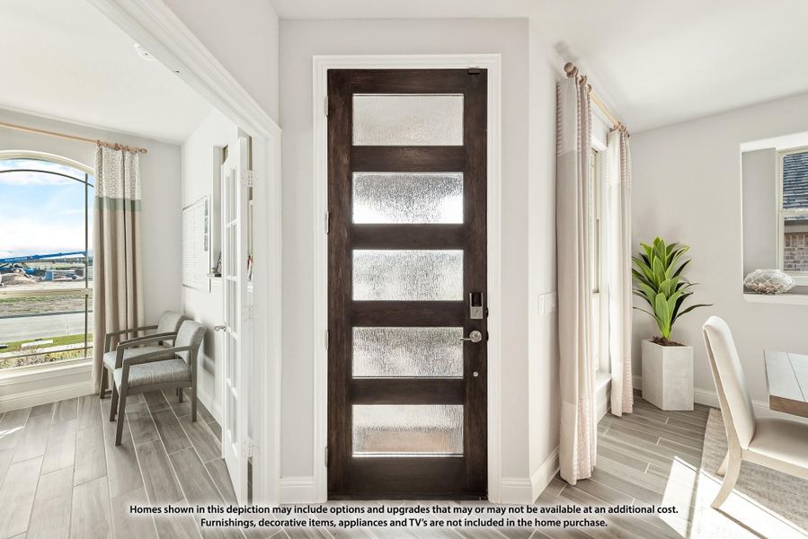 Entryway with dark wood front door featuring five frosted glass panels and light gray tile floors Entryway with dark wood front door featuring five frosted glass panels and light gray tile floors